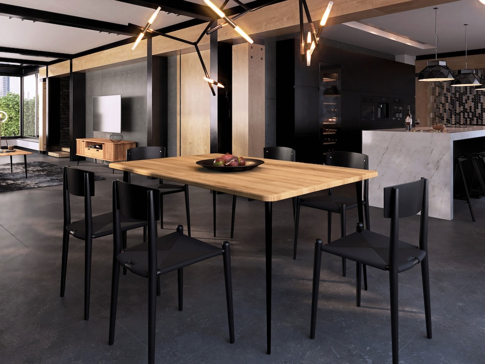 De zwarte metalen poten accentueren op indrukwekkende wijze het tafelblad, hier gemaakt van massief kernbeuken