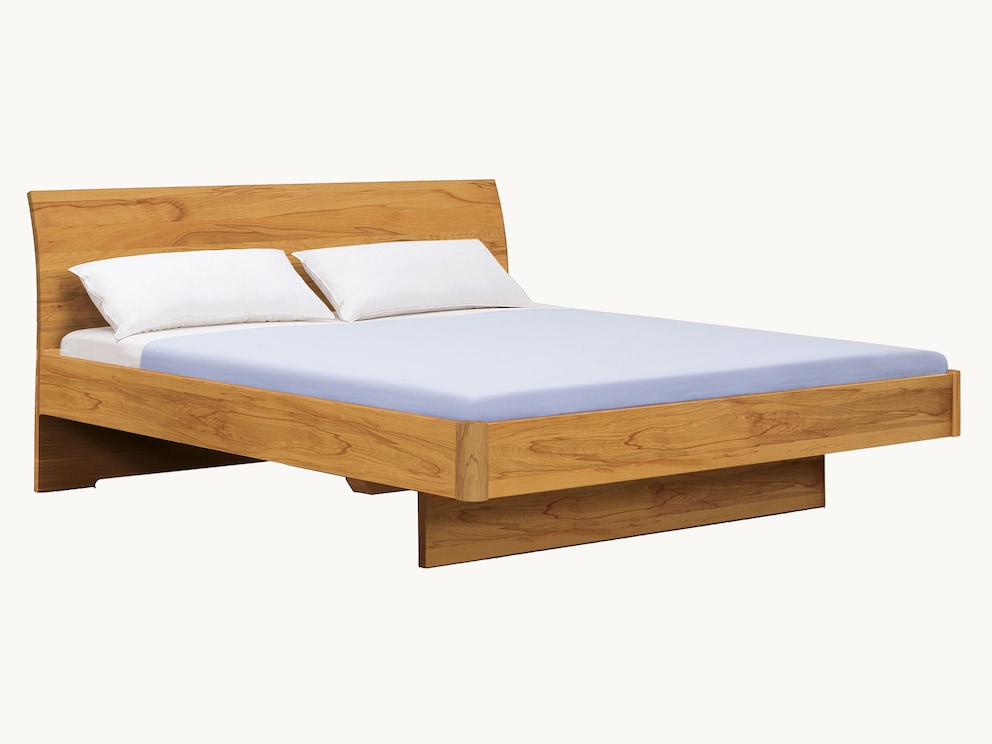 Edel zwevend bed met comfortabel gebogen hoofdbord, hier in massief noten