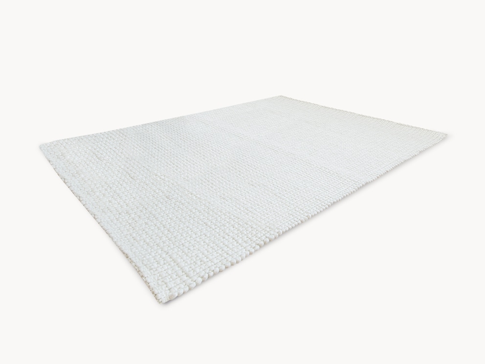Tapis en laine vierge « Crusado » tissé à la main avec une structure unique, ici en beige