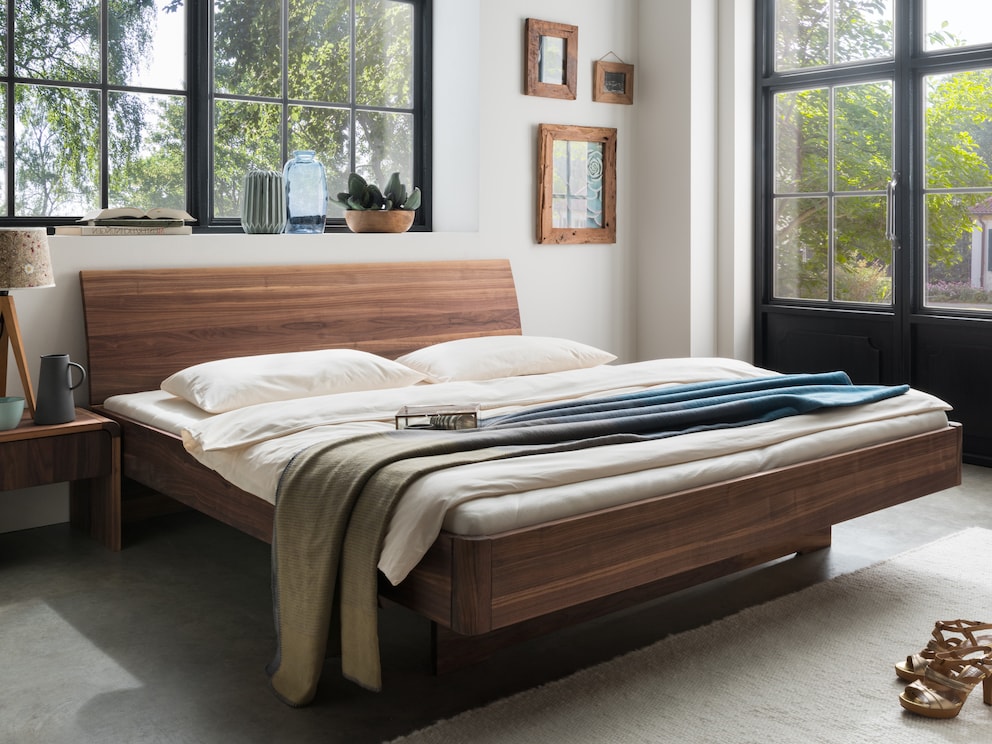 Lit suspendu noble avec tête de lit confortablement incurvée, ici en noyer massif